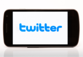   Cell phone with Twitter written in blue text
